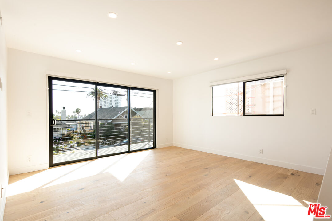 2811 3rd Street, Unit 1 Santa Monica, CA 90405 - Photo 3 of 21 an empty room with wooden floor and windows