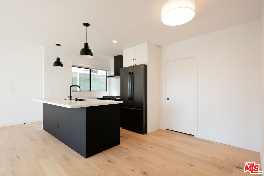 2811 3rd Street, Unit 1 Santa Monica, CA 90405 - Photo 4 of 21 a kitchen with stainless steel appliances kitchen island granite countertop a refrigerator a sink and a stove