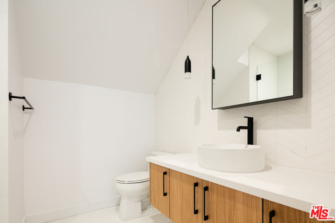 2811 3rd Street, Unit 1 Santa Monica, CA 90405 - Photo 10 of 21 a bathroom with a sink a toilet and mirror