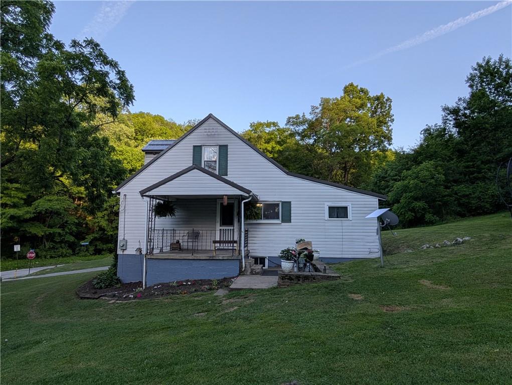 205 Woods Road Ligonier, PA 15658 - Photo 25 of 32 a front view of a house with garden