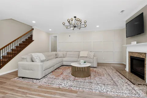 a living room with furniture and a fireplace
