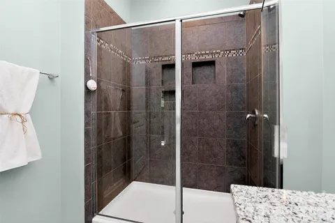 a bathroom with a shower and a sink