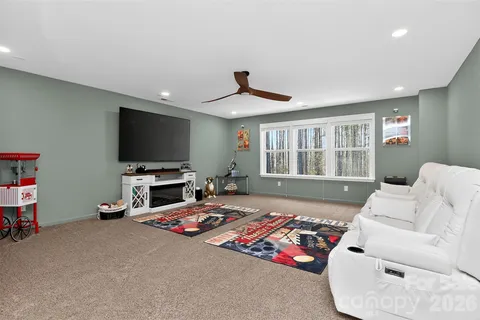 a bedroom with furniture and a flat screen tv