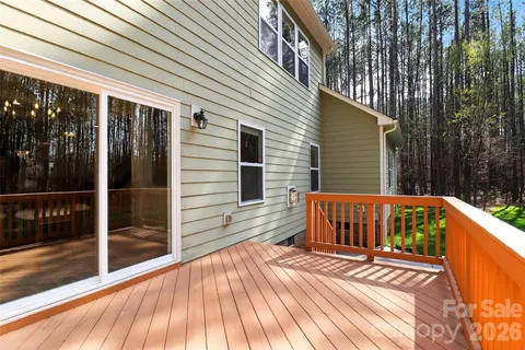 a view of backyard with deck and a garden