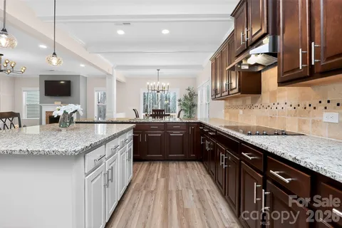 a kitchen with stainless steel appliances granite countertop a sink wooden cabinets and a granite counter tops