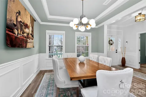 a view of a dining room with furniture wooden floor and chandelier