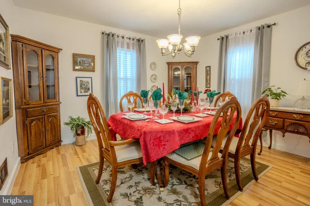 a view of a dining room with furniture wooden floor and chandelier