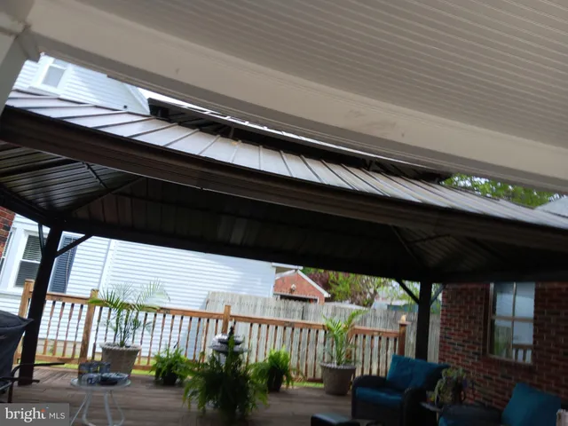 a yellow building in the middle of a yard