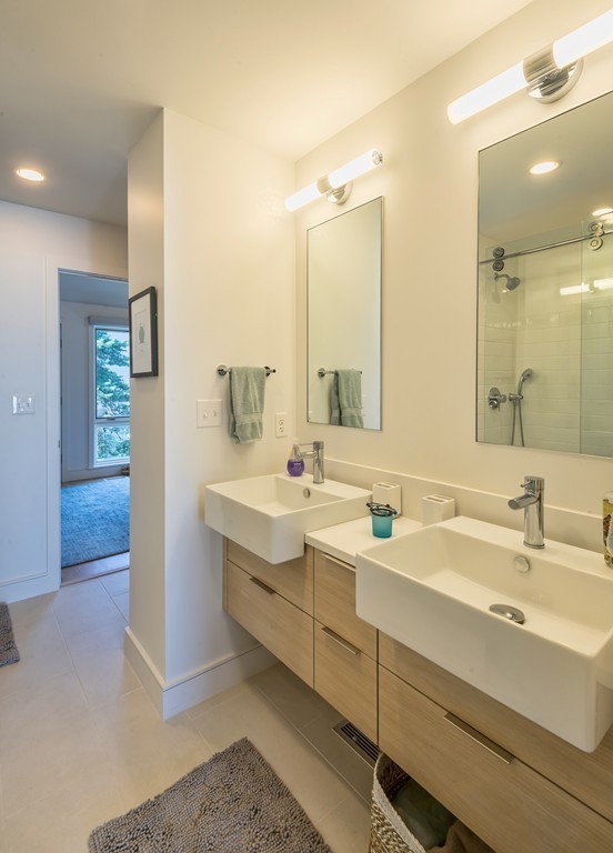 31 Constitution Way, Unit 31 Marblehead, MA 01945 - Photo 19 of 30 a bathroom with a double vanity sink mirror and double