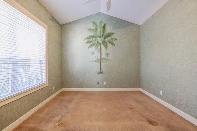 a view of room with window and a ceiling fan
