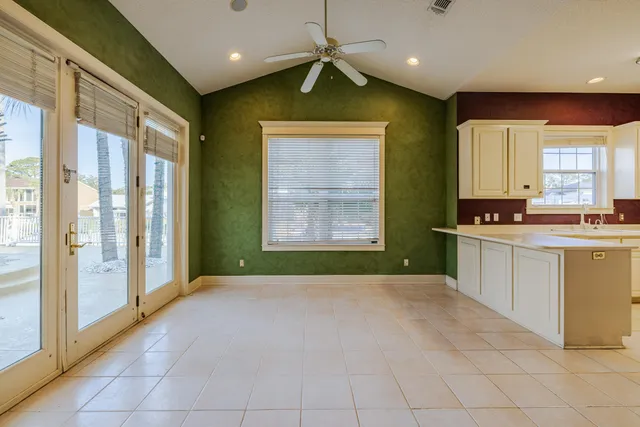 a kitchen that has a lot of cabinets in it and a window