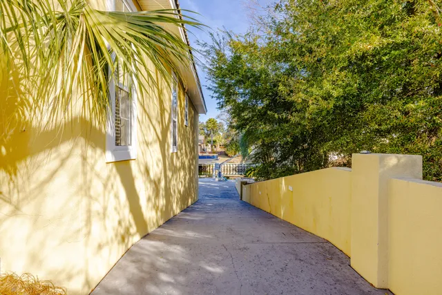 a view of a house with a yard and potted plants
