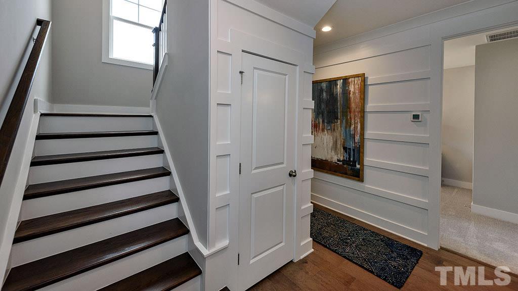 6948 Leesville Road, Unit 14 Raleigh, NC 27613 - Photo 11 of 19 a view of a hallway with wooden floor and staircase