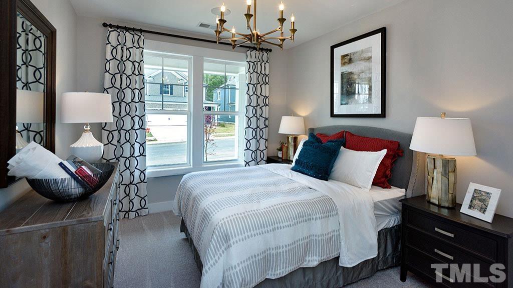 6948 Leesville Road, Unit 14 Raleigh, NC 27613 - Photo 13 of 19 a bedroom with a bed and a chandelier