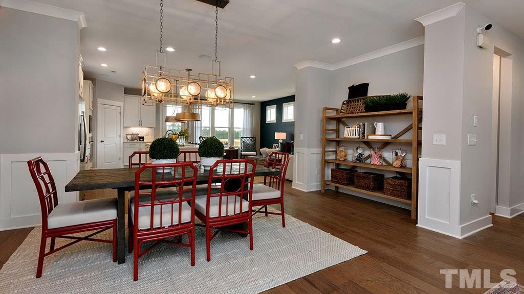 6948 Leesville Road, Unit 14 Raleigh, NC 27613 - Photo 15 of 19 a dining room with furniture a rug and wooden floor