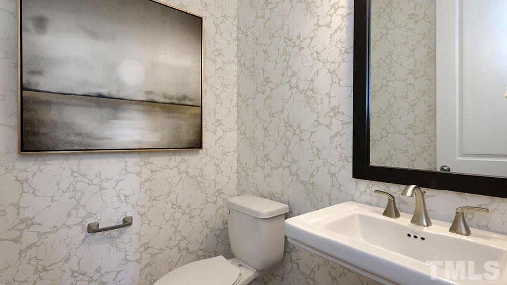 6948 Leesville Road, Unit 14 Raleigh, NC 27613 - Photo 7 of 19 a bathroom with a sink and a mirror