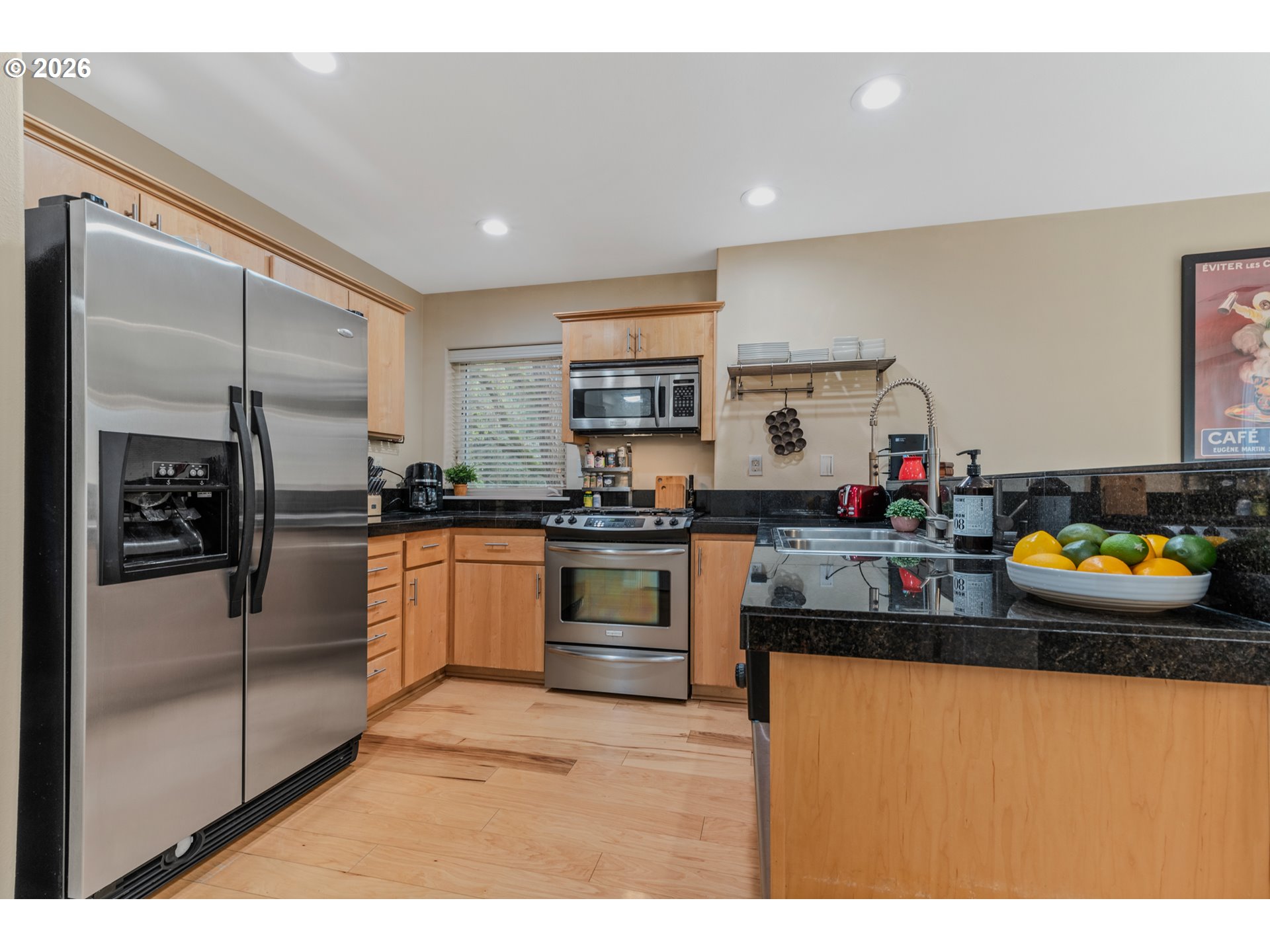 2924 Southwest Tranquility Terrace Beaverton, OR 97003 - Photo 13 of 39 a kitchen with stainless steel appliances granite countertop a refrigerator and a sink