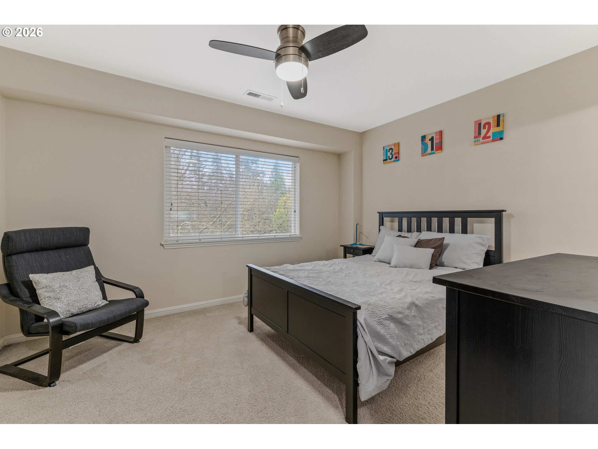 2924 Southwest Tranquility Terrace Beaverton, OR 97003 - Photo 18 of 39 a bedroom with a bed a desk and chair