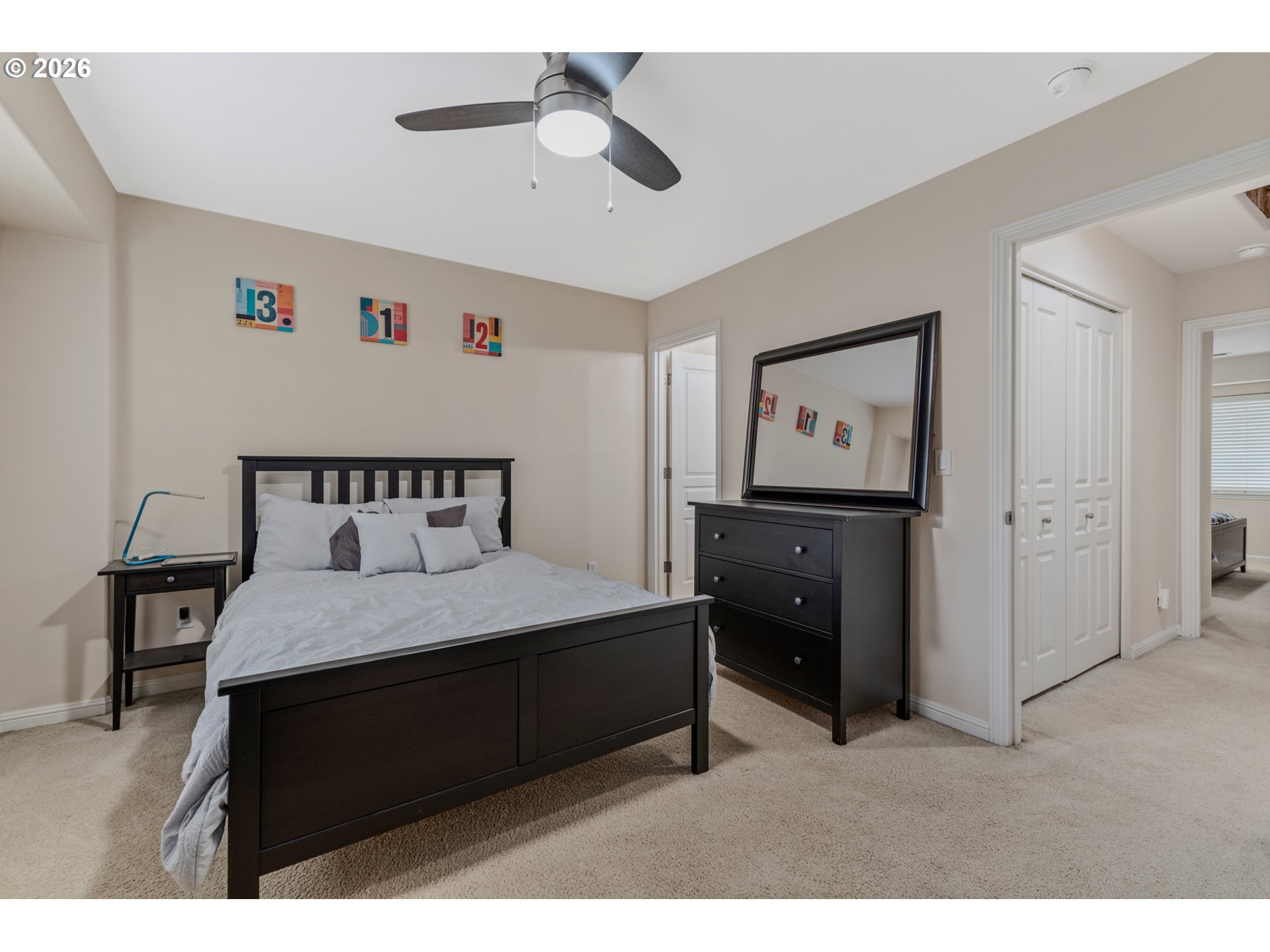2924 Southwest Tranquility Terrace Beaverton, OR 97003 - Photo 19 of 39 a bedroom with a bed and a chandelier