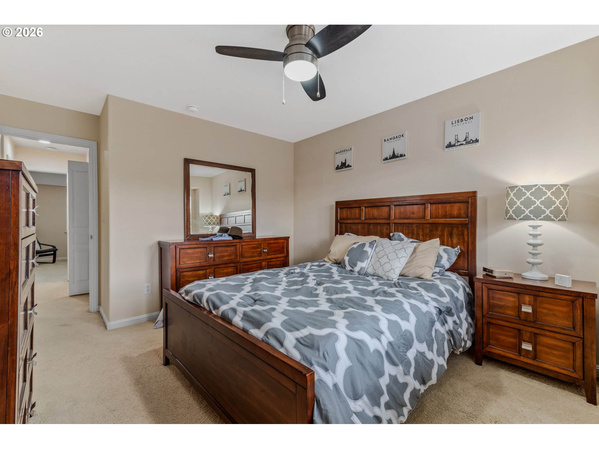 2924 Southwest Tranquility Terrace Beaverton, OR 97003 - Photo 26 of 39 a bedroom with a bed a dresser and a chandelier