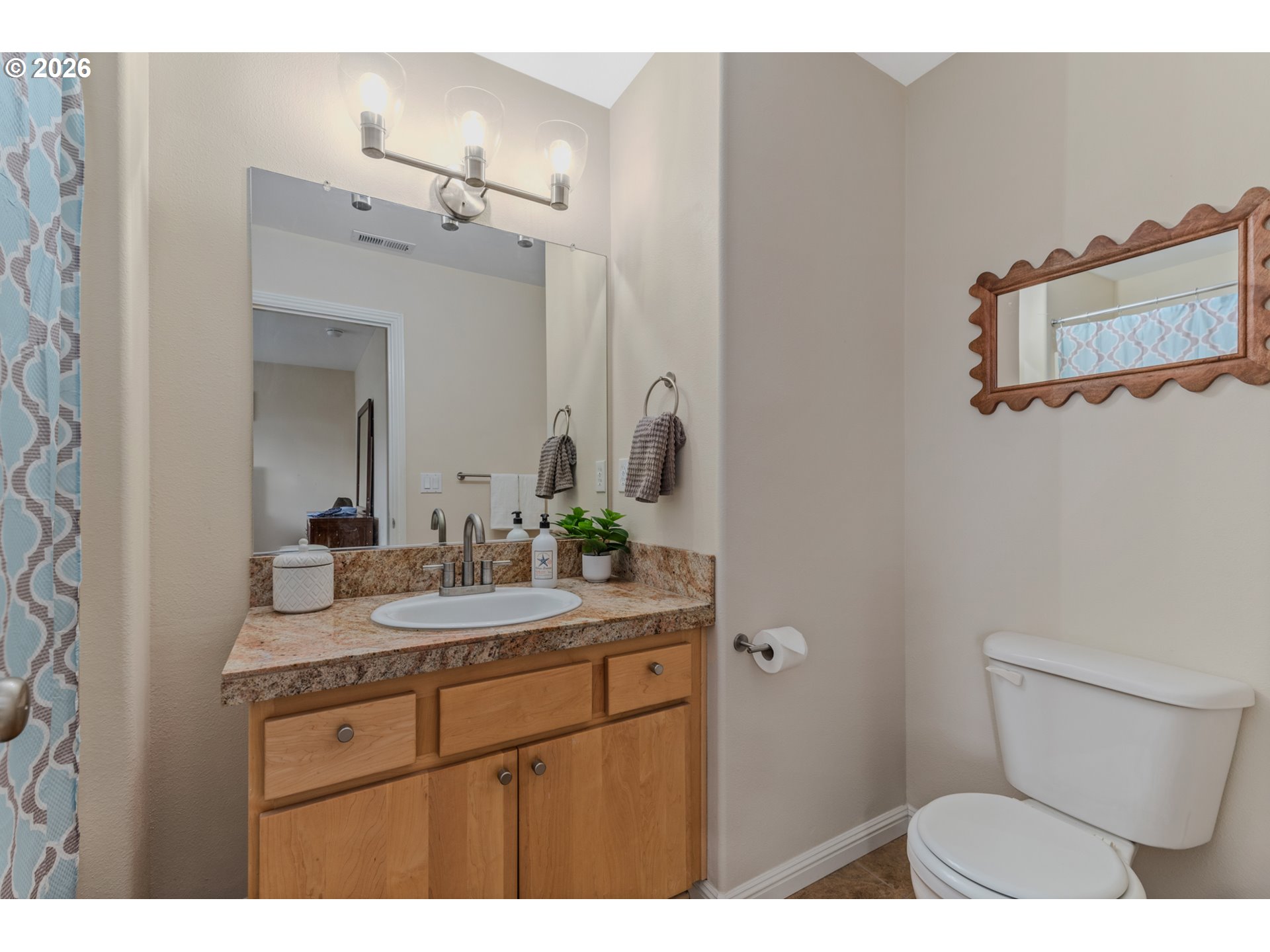 2924 Southwest Tranquility Terrace Beaverton, OR 97003 - Photo 29 of 39 a bathroom with a granite countertop sink a toilet and mirror