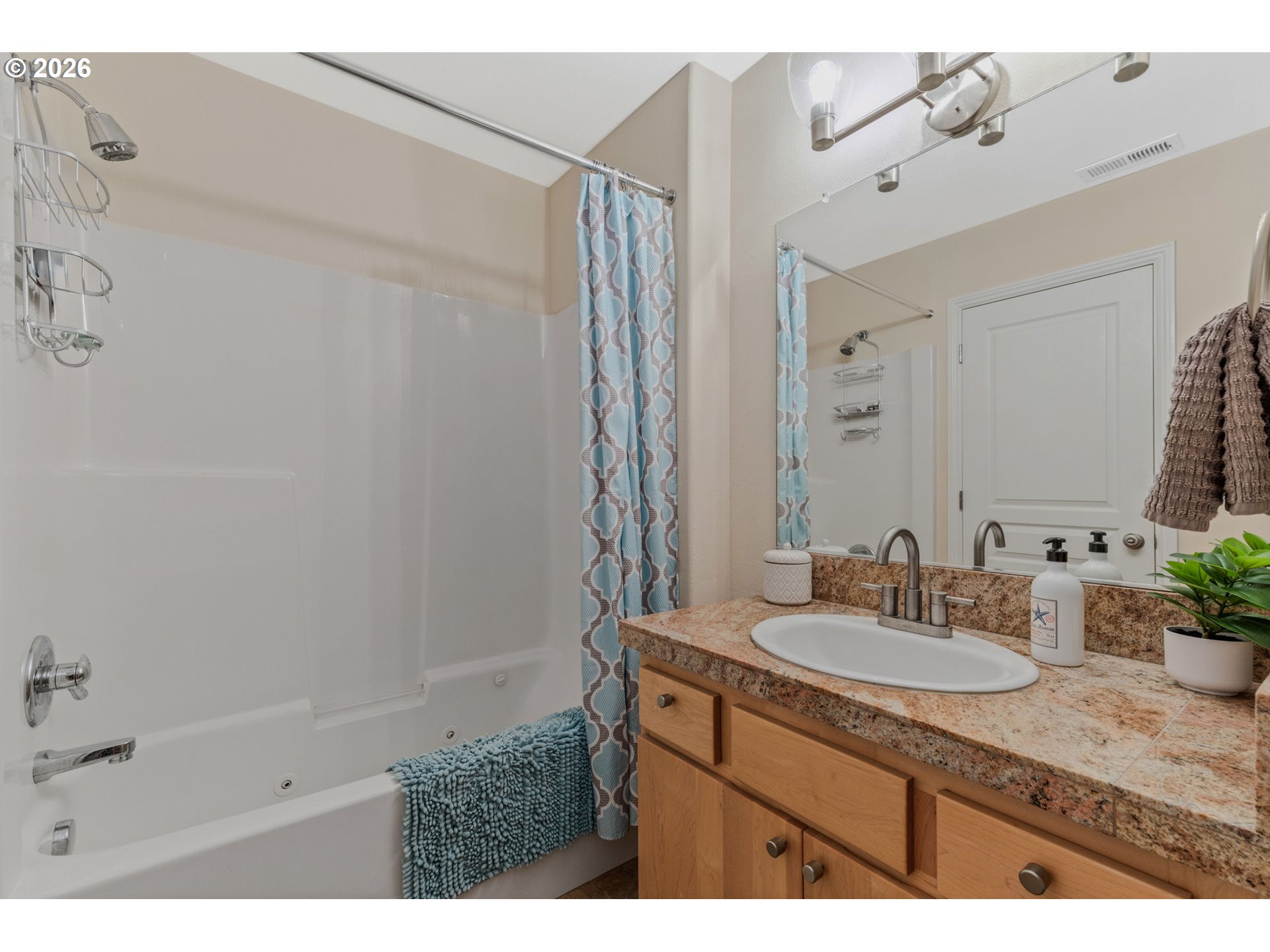 2924 Southwest Tranquility Terrace Beaverton, OR 97003 - Photo 30 of 39 a bathroom with a granite countertop sink a mirror and a shower