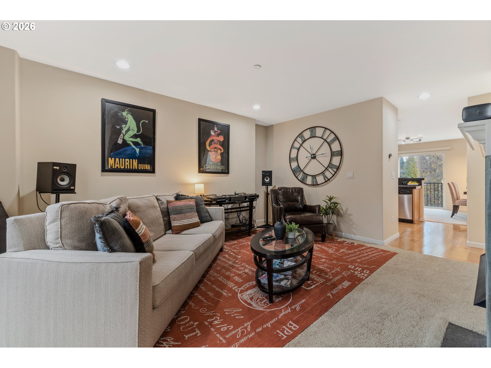 2924 Southwest Tranquility Terrace Beaverton, OR 97003 - Photo 7 of 39 a living room with furniture a clock and a view of kitchen