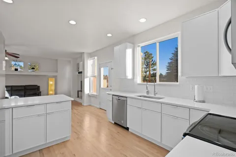 a kitchen with a sink stove and cabinets