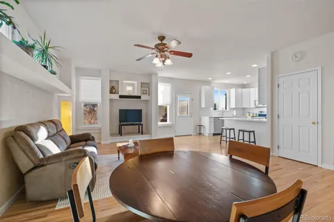 a living room with fireplace furniture and a wooden floor