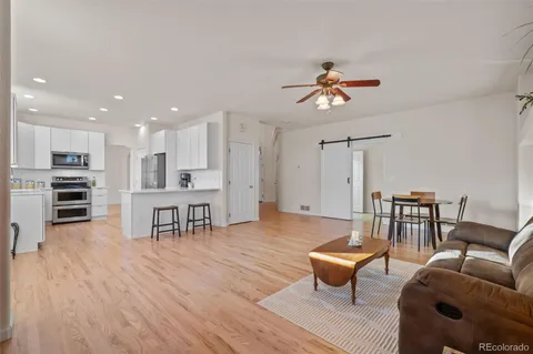 a living room with furniture and kitchen view