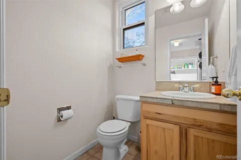 a bathroom with a toilet a sink and mirror