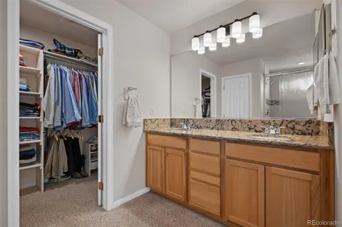 a bathroom with a double vanity sink a and a mirror