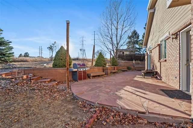 a view of a patio with a table chairs and a fire pit