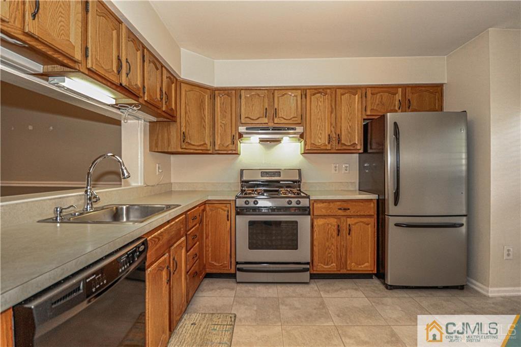 2305 Timber Oaks Road Edison, NJ 08820 - Photo 3 of 33 a kitchen with stainless steel appliances granite countertop a refrigerator and a sink