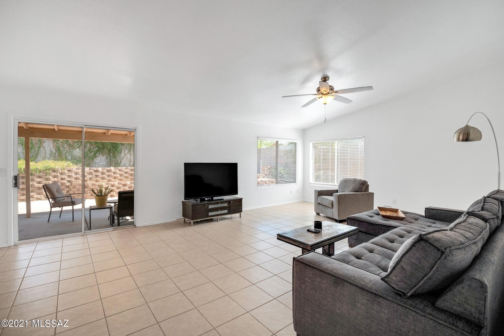 9671 East Azuma Way Tucson, AZ 85747 - Photo 11 of 31 a living room with furniture and a flat screen tv
