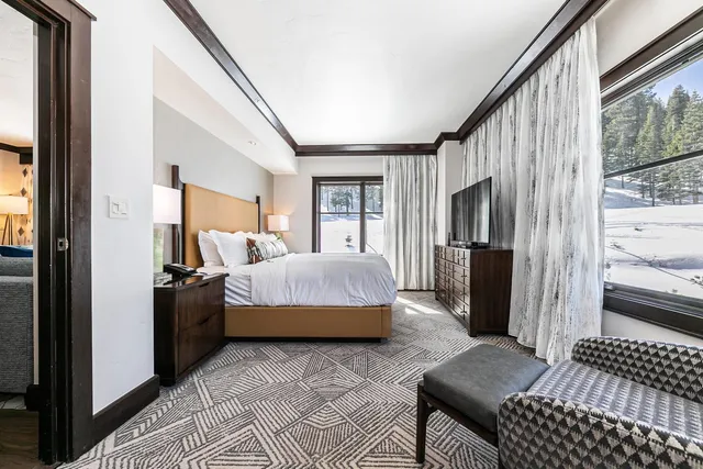 a bedroom with furniture and a flat screen tv