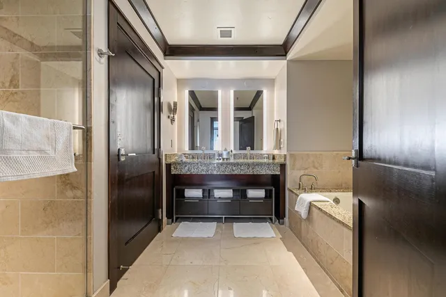 a bedroom with a large bed and a night stand