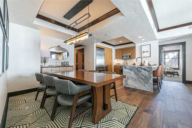 a dining room with furniture and wooden floor