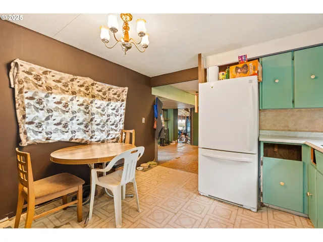 a view of a dining room with furniture and a kitchen