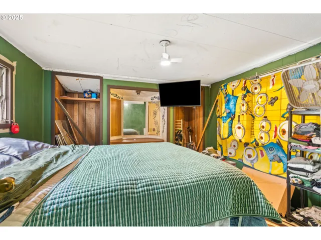 a bedroom with a bed and a television