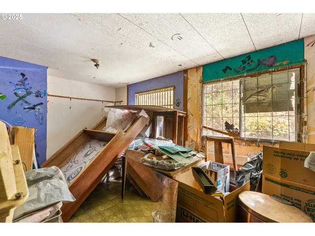 a living room with furniture a flat screen tv and a window
