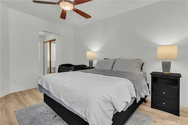 a bedroom with a bed and a lamp