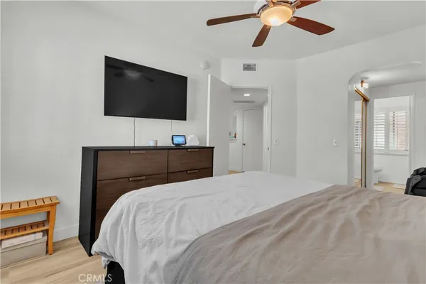 a bedroom with a bed and a flat screen tv