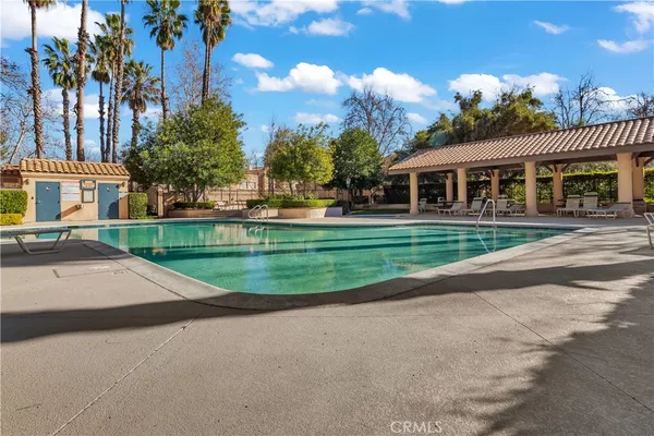 a front view of a house with a yard and potted plants