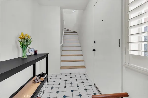 a view of a hallway with wooden floor and windows