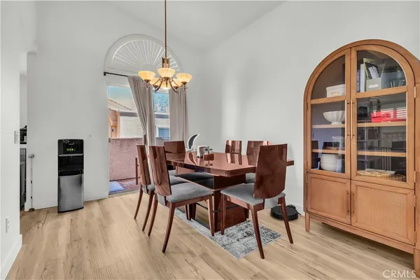 a view of a dining room with furniture and chandelier