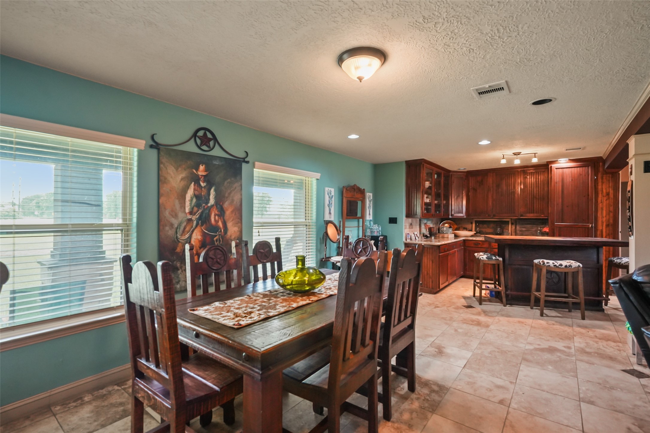 34366 Owens Road Hempstead, TX 77445 - Photo 8 of 46 Bright dining area with large windows, generous space for entertaining, and an open-concept layout that flows seamlessly into the kitchen and living room.