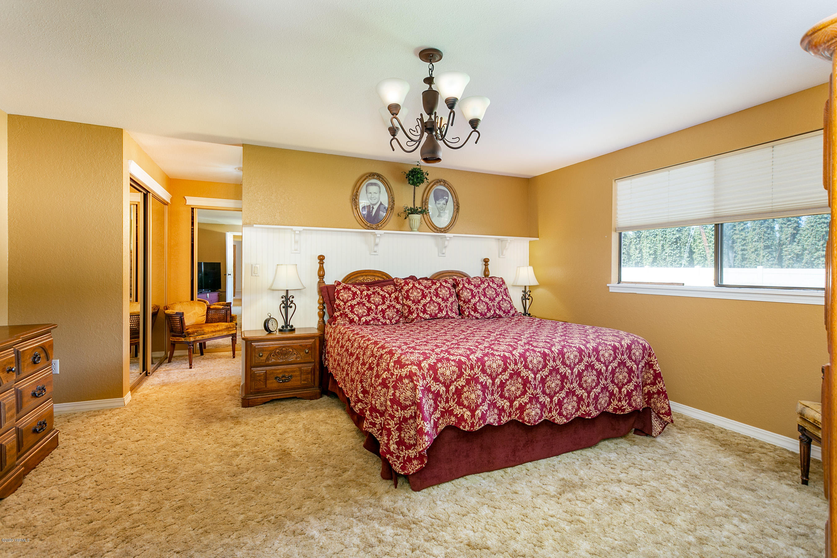 2770 South Satus Road Toppenish, WA 98948 - Photo 13 of 41 a bedroom with a bed and a chandelier