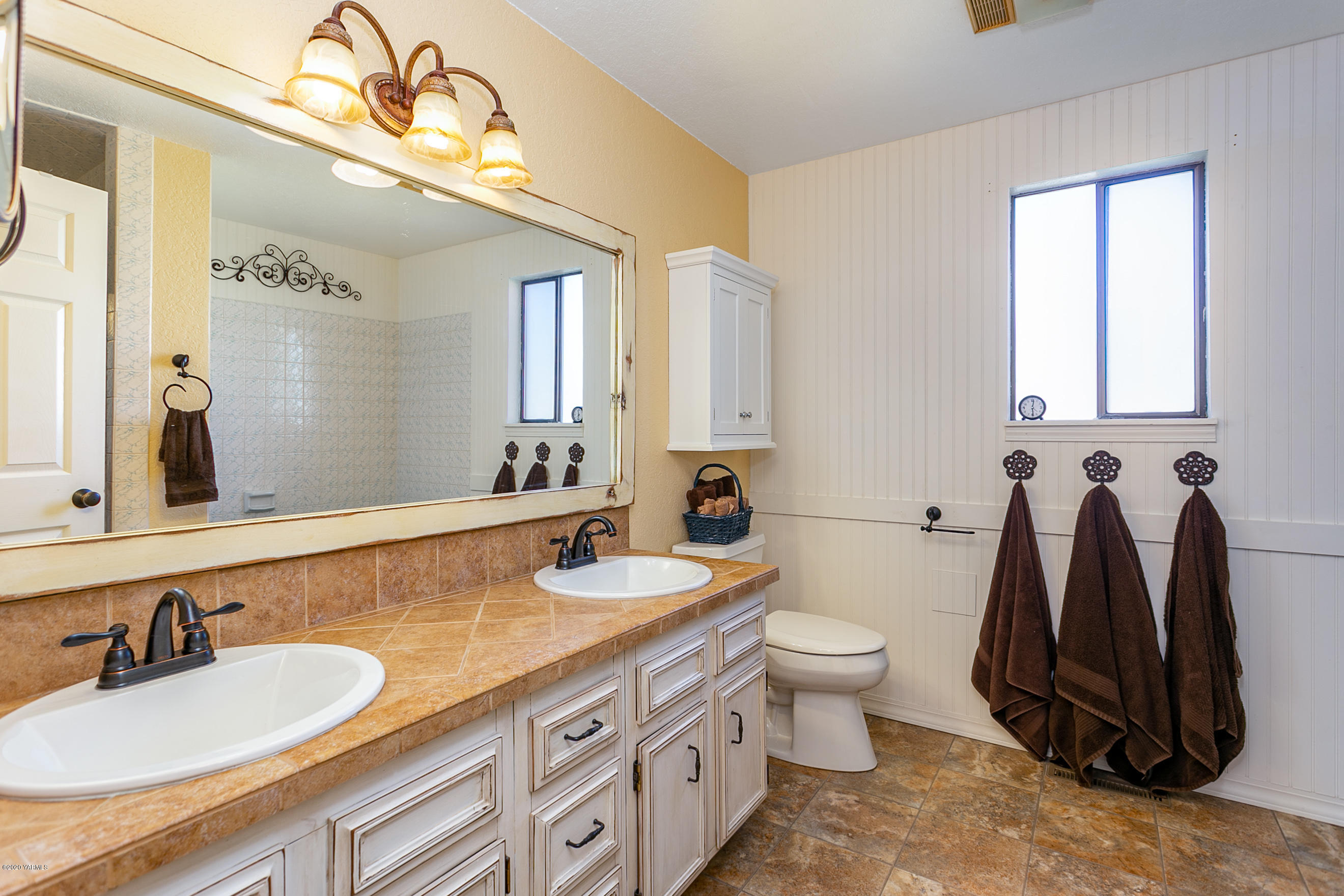 2770 South Satus Road Toppenish, WA 98948 - Photo 18 of 41 a bathroom with a double vanity sink and a toilet