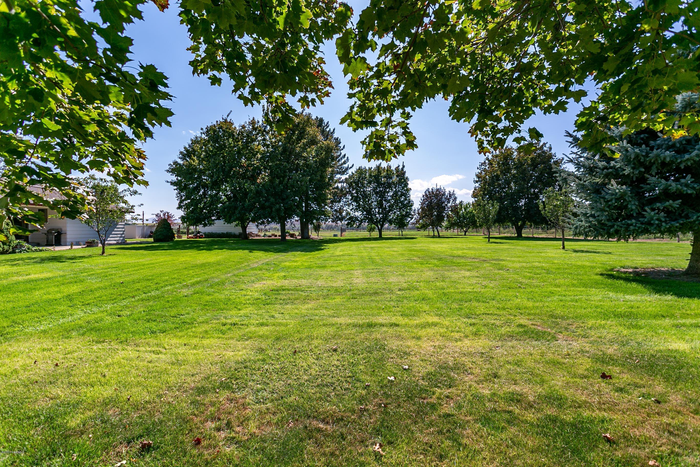 2770 South Satus Road Toppenish, WA 98948 - Photo 28 of 41 a backyard of a house with lots of green space and fountain